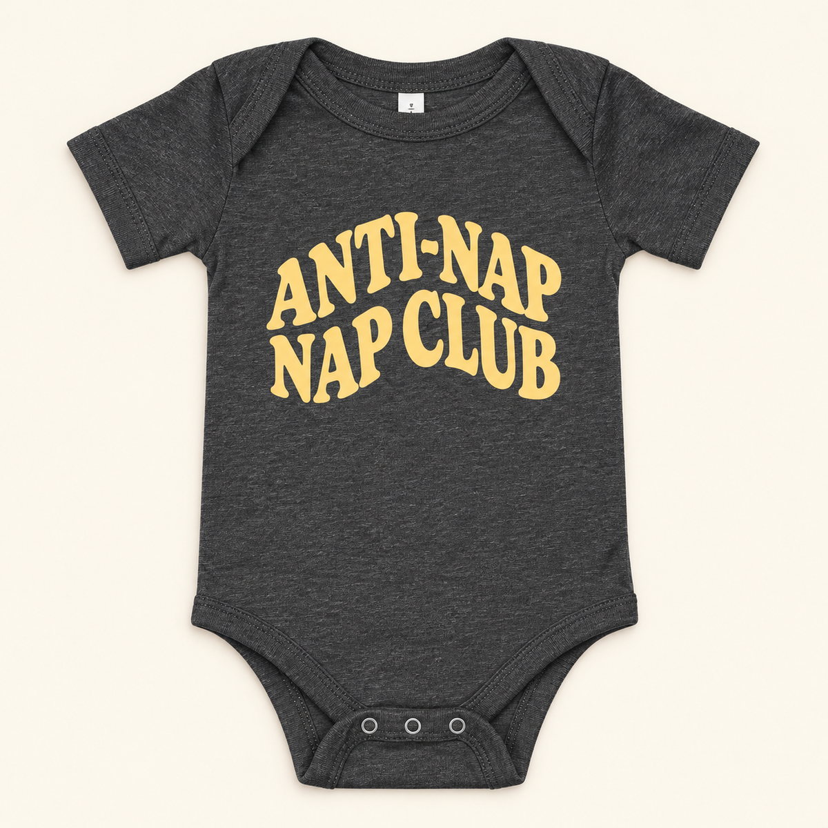 Dark Grey Heather baby bodysuit with yellow Anti-Nap Nap Club lettering, front view