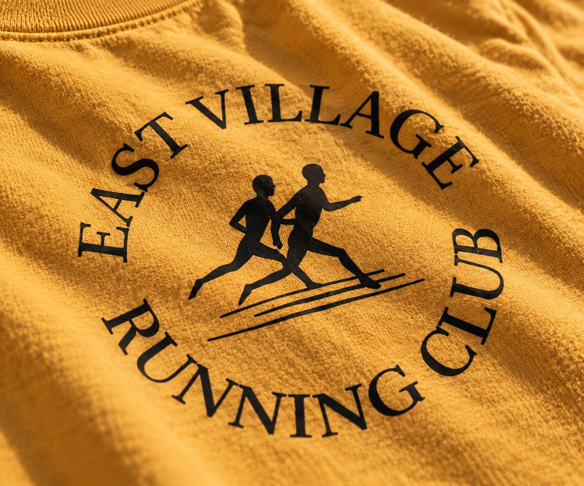 East Village Running Club mustard tee print detail