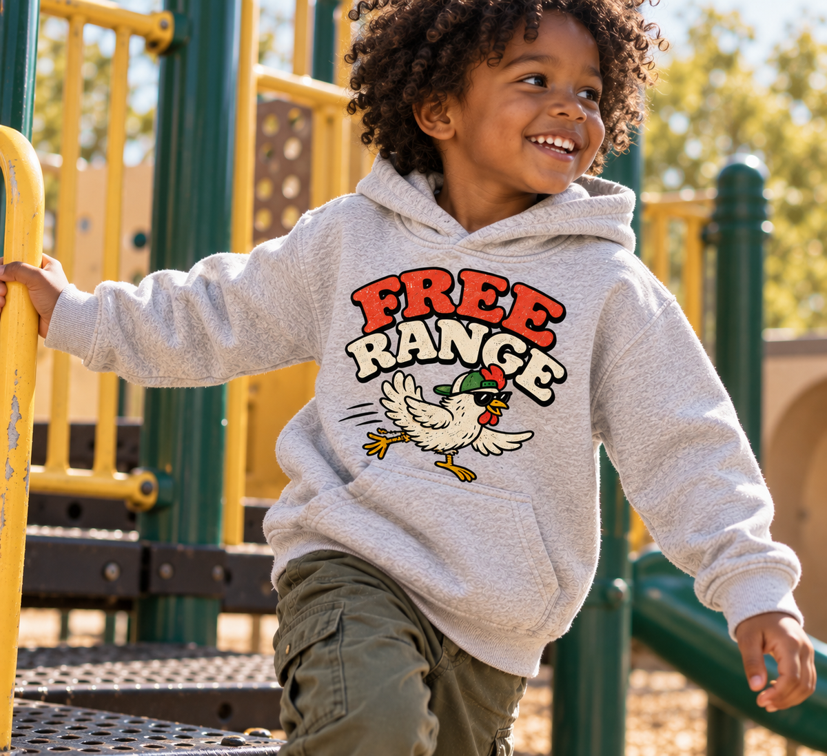 Child wearing Free Range heather toddler hoodie at playground