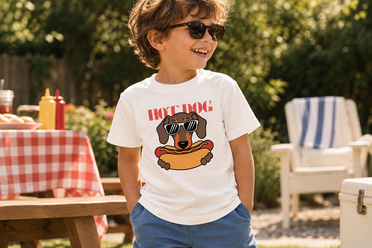 Kid wearing Hot Dog white graphic tee at a backyard cookout